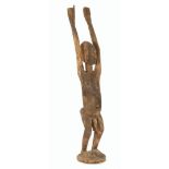 Wooden ceremonial statue of a man with amulet