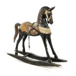 Wooden rocking horse with textile decoration