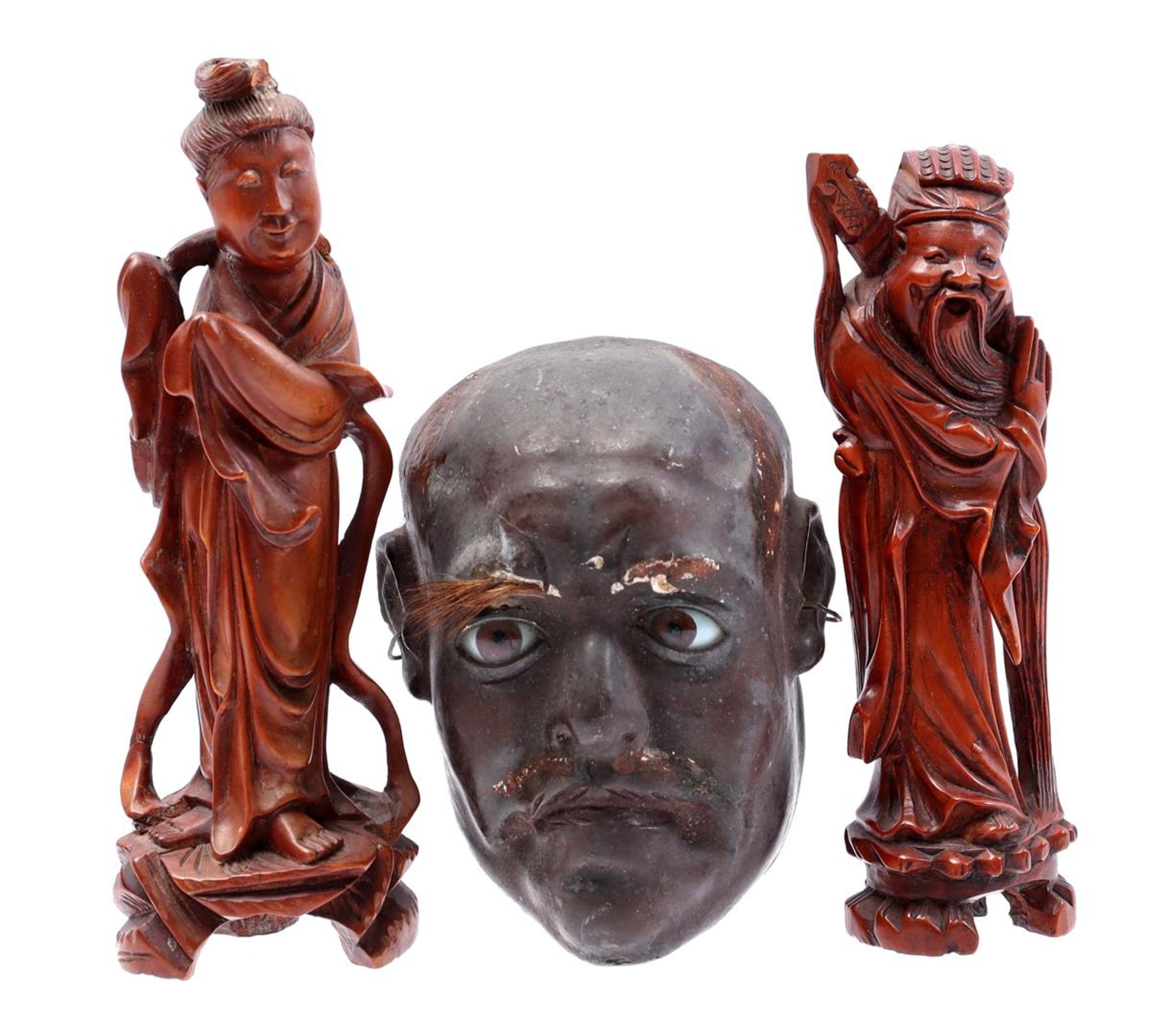 2 wooden statues and plaster mask