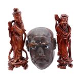 2 wooden statues and plaster mask