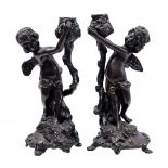 1 pair of bronze putti candlesticks