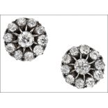 A pair of diamond cluster ear studs, set throughout with old round brilliant-cut diamonds, total