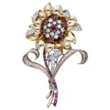 A ruby and diamond set flower brooch, circa 1940/50, the large flowerhead centred with a pierced...