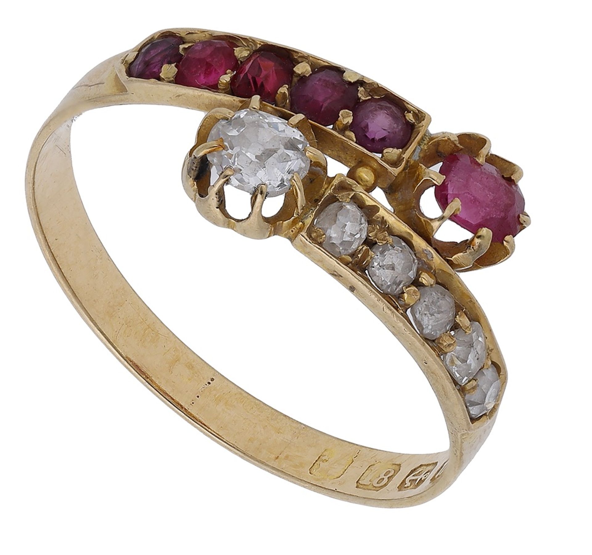 A ruby and diamond crossover ring, 1911, the terminals set with a cushion-shaped ruby and old br...