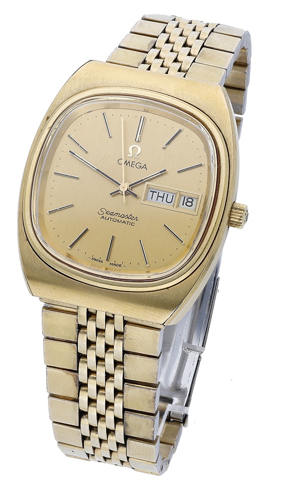 Omega. A gold plated tonneau-form automatic wristwatch with day, date and bracelet, Seamaster, ci...