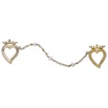 A Victorian gold double heart brooch, one heart of plain polished finish, the second with engrave...