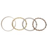 Four bangles, comprising a plain polished 9ct gold bangle, a hollow bangle, stamped â€˜14Kâ€™, an op