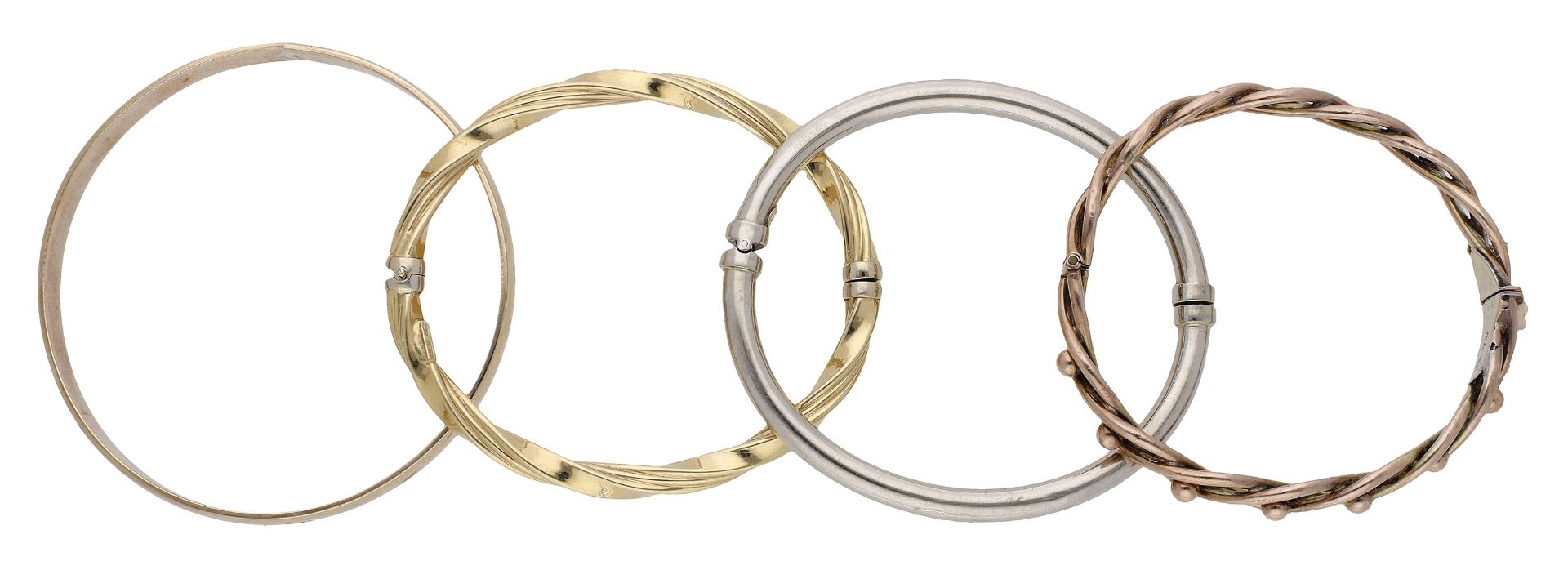 Four bangles, comprising a plain polished 9ct gold bangle, a hollow bangle, stamped â€˜14Kâ€™, an op