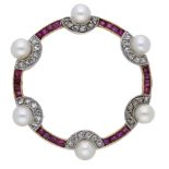 An early 20th century ruby, cultured pearl, and diamond hoop brooch, set with a series of calibrÃ©..