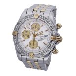 Breitling. A stainless steel, gold and diamond-set automatic chronograph wristwatch with date and...