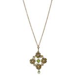 An early 20th century peridot and seed pearl flowerhead pendant, set with a circular-cut peridot...