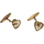A pair of citrine cufflinks, the faceted heart-shaped citrines with hollow ovoid terminals,...