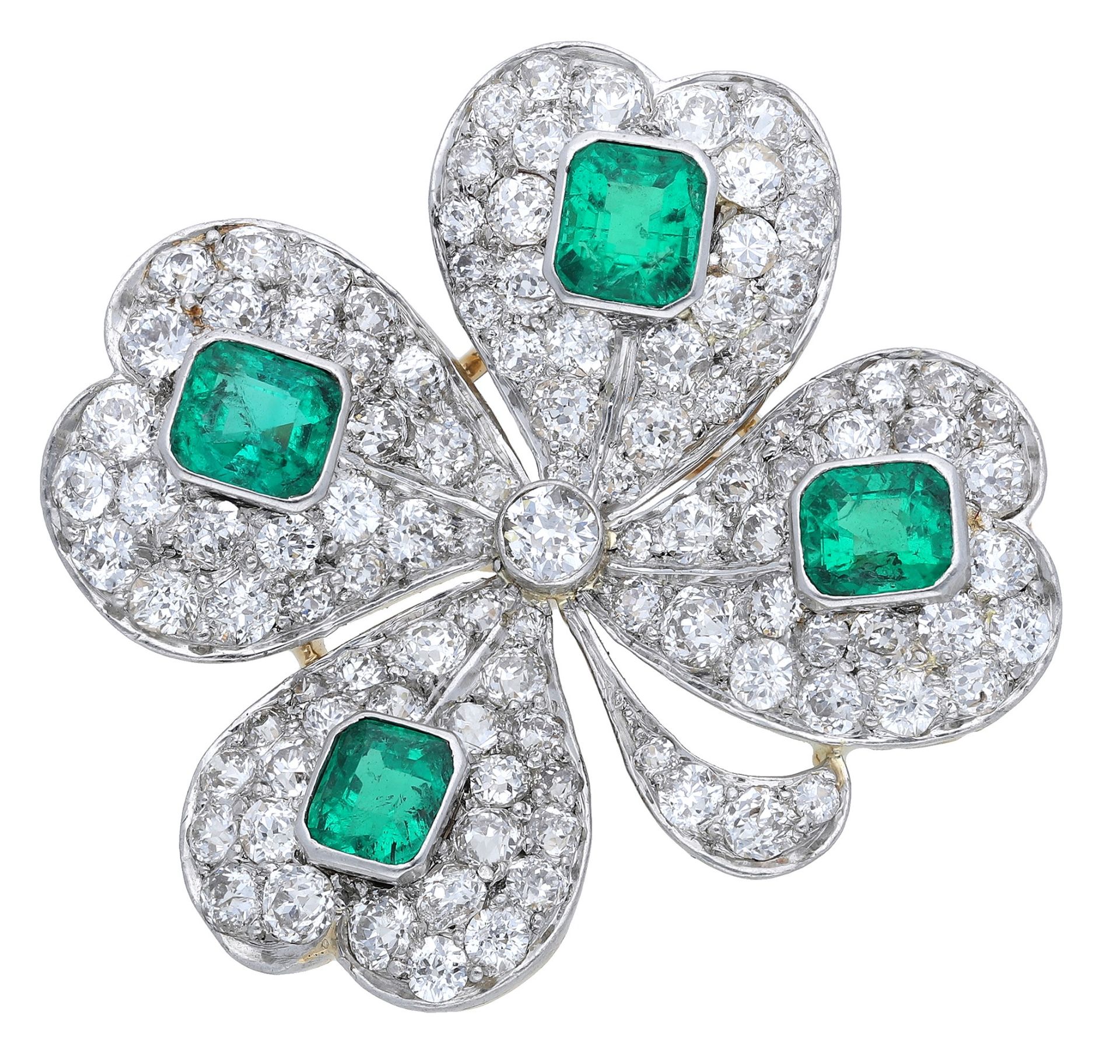 An emerald and diamond brooch, the early 20th century jewel designed as a four-leaf clover,...