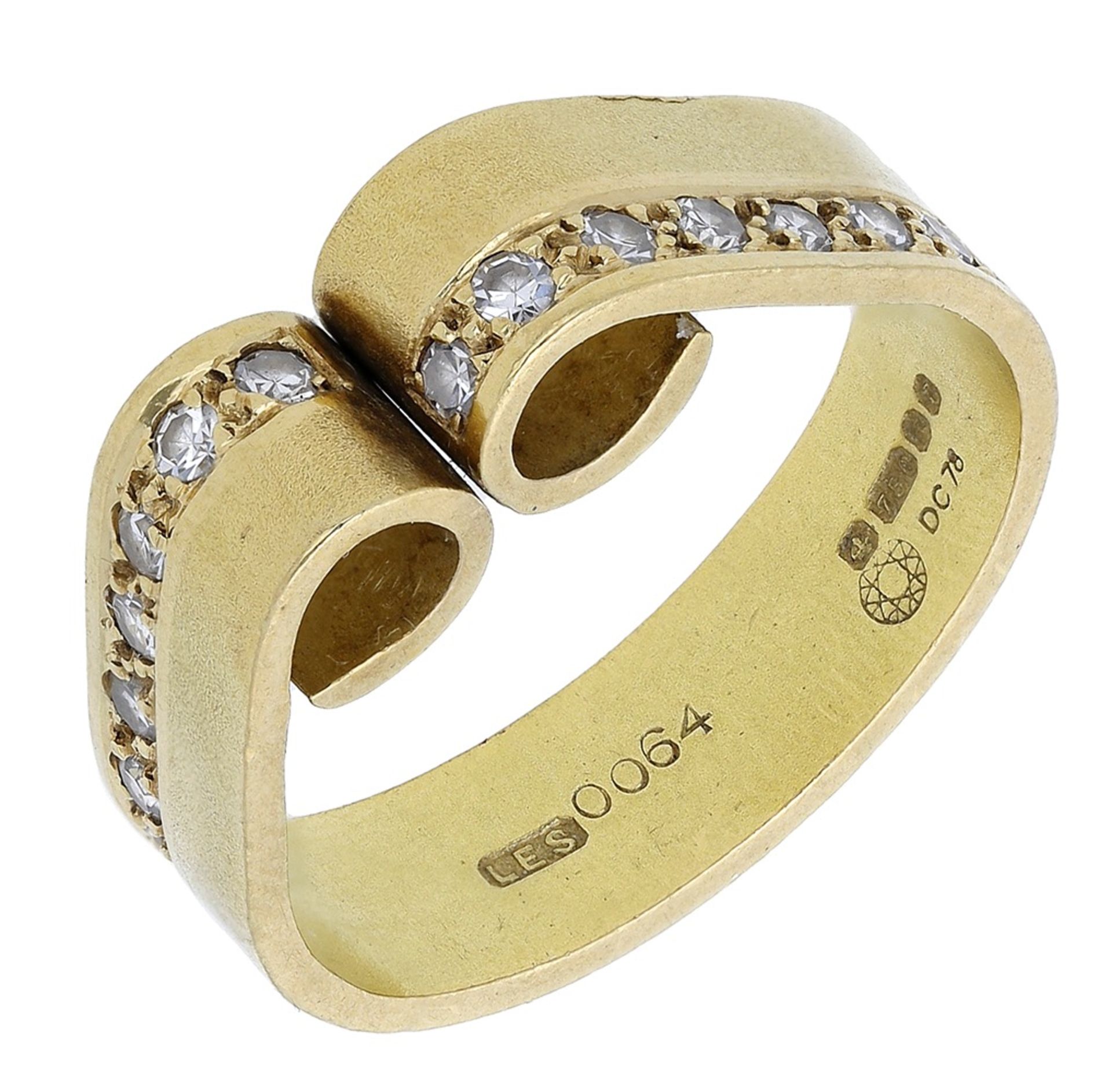 A diamond scroll ring, 1977, composed of two bold scrolls, each side inset with a row of sin...