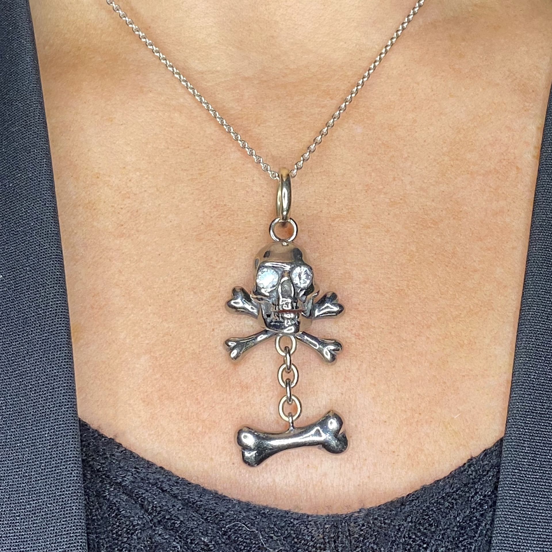 A diamond skull and cross bones pendant, the eyes set with brilliant-cut diamonds, the whole... - Image 3 of 3