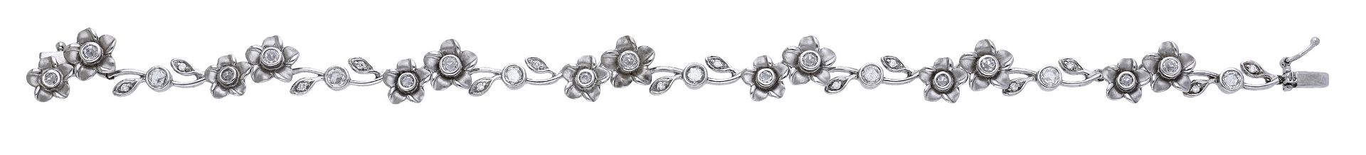 An 18ct white gold and diamond flowerhead bracelet, the diamond-set flowerhead duos spaced b...