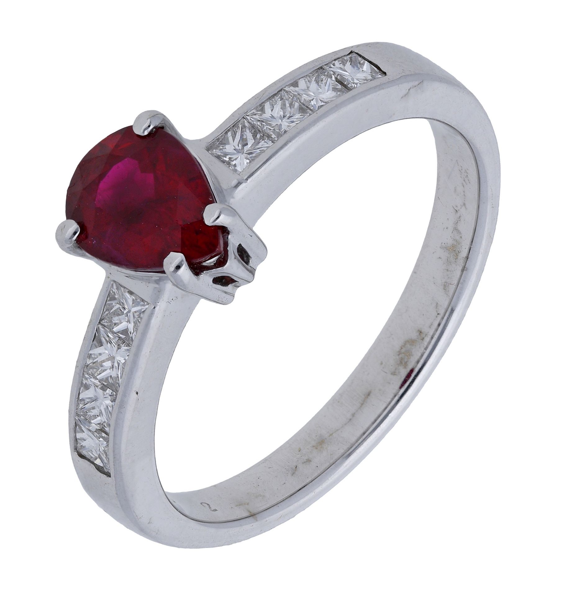 A ruby and diamond ring, the pear-shaped ruby claw-set to princess-cut diamond shoulders, st...