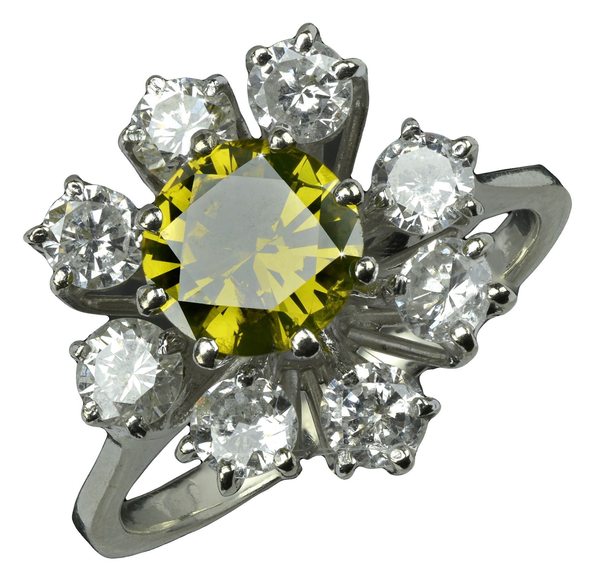 A diamond cluster ring, the central brilliant-cut diamond of yellow tint within an undulatin...