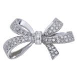 A diamond bow brooch, the highly polished mount set throughout with brilliant and baguette-c...