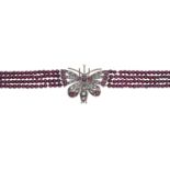 A garnet bead necklace with gem-set butterfly clasp, the four uniform rows of garnet beads t...