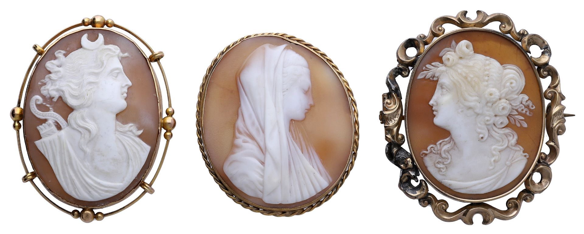 Three late 19th/early 20th century shell cameo brooches, the first carved to depict Diana th...