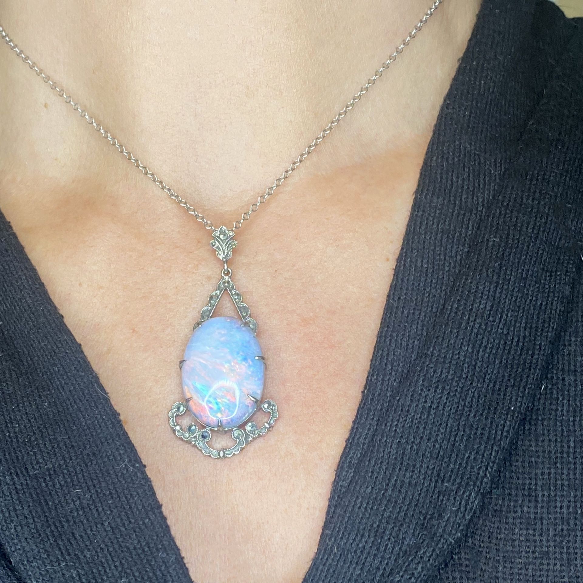 An opal pendant, the oval opal cabochon in a geometric surround set with faceted marcasite,... - Image 3 of 3