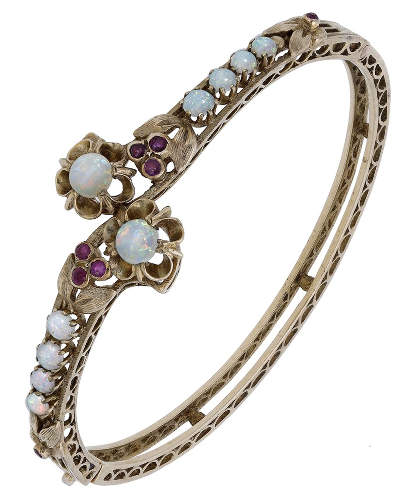 An opal and ruby crossover bangle, the hinged bangle set to the front with opal cabochons an...