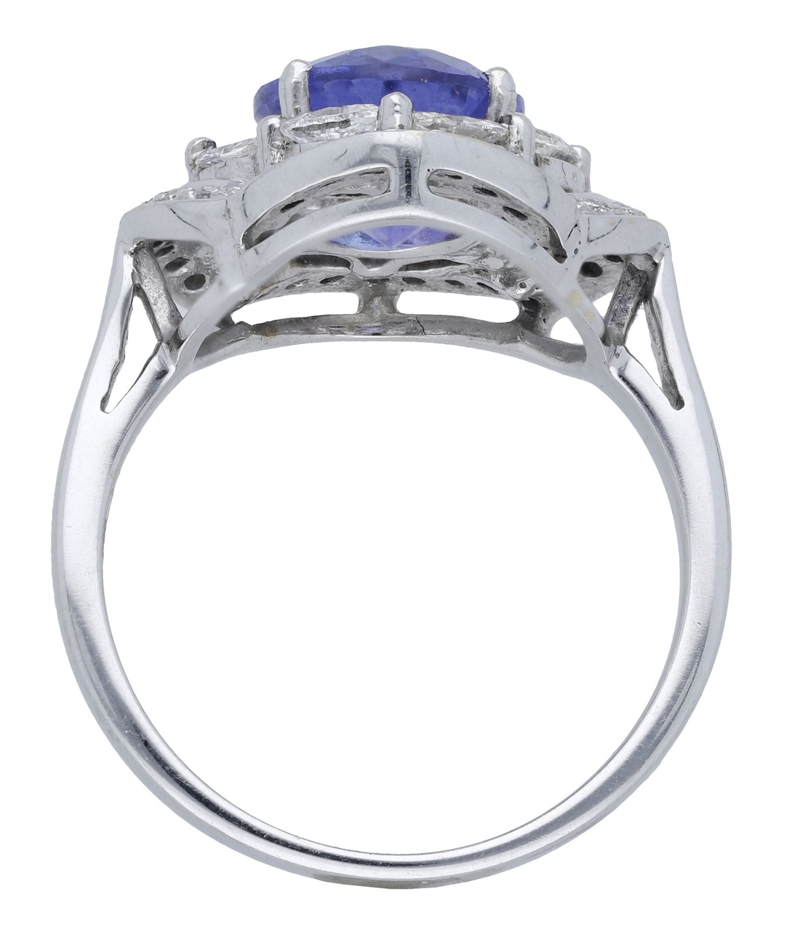 A tanzanite and diamond cluster ring, set with an oval mixed-cut tanzanite within an undulat... - Image 3 of 4