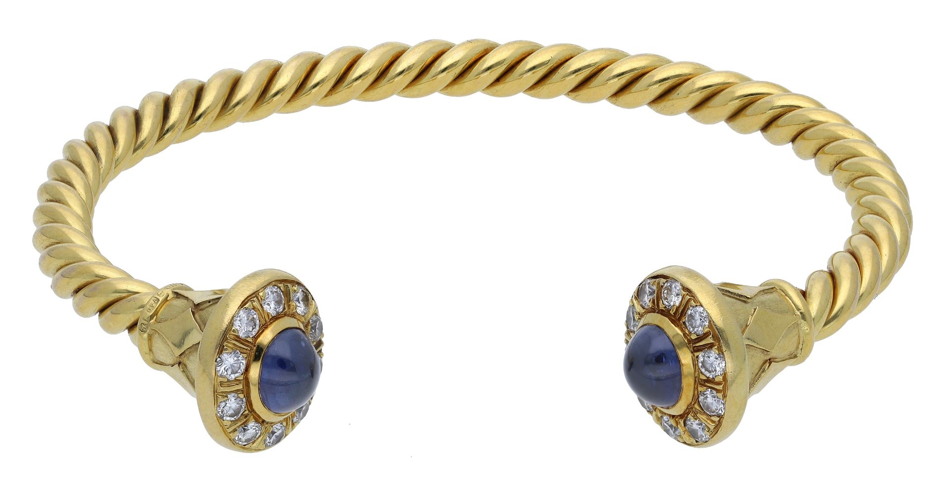 An 18ct gold sapphire and diamond torque bangle, the ropetwist bangle with fluted terminals,...