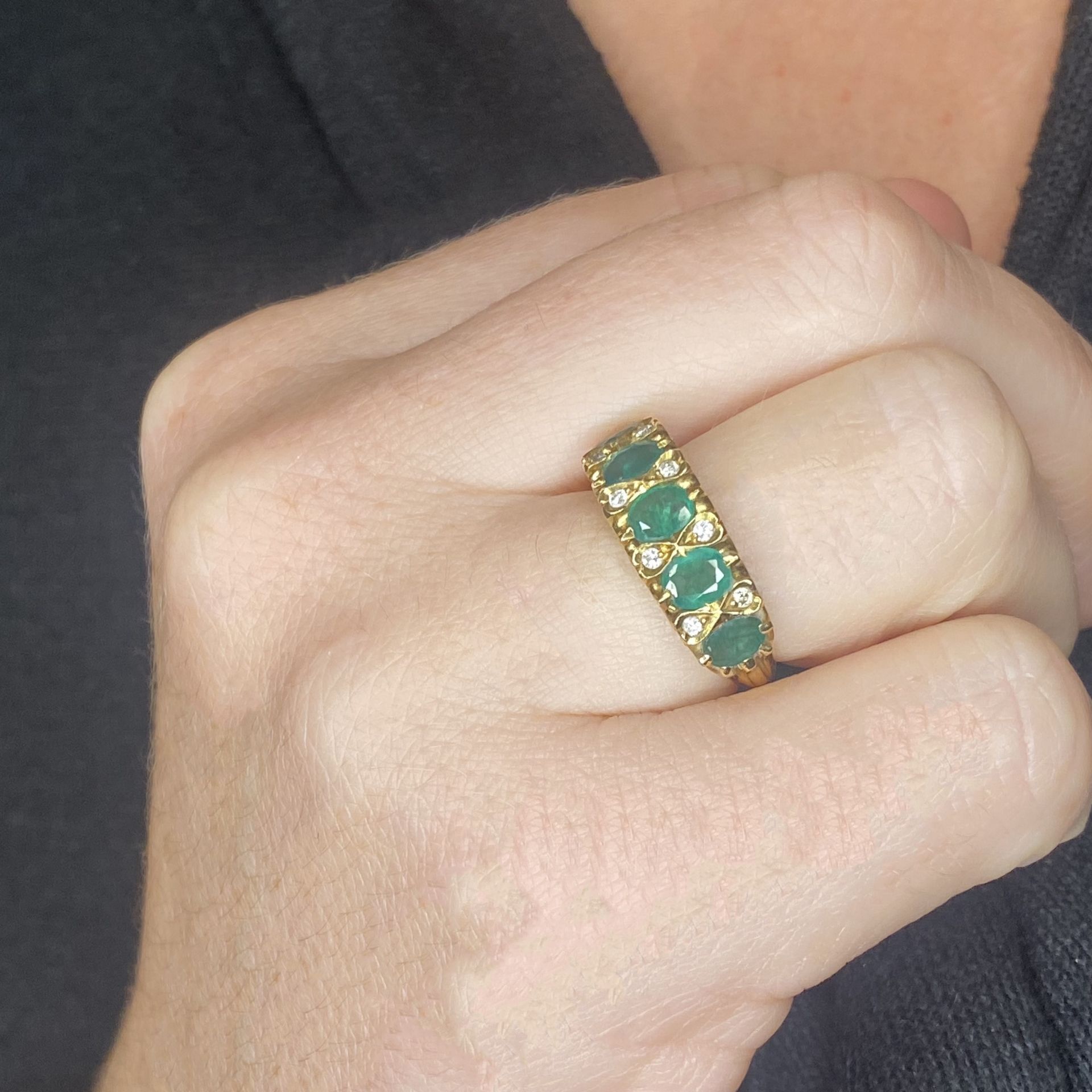 An emerald ring, set with five oval-cut emeralds, with brilliant-cut diamond highlights betw... - Image 3 of 3