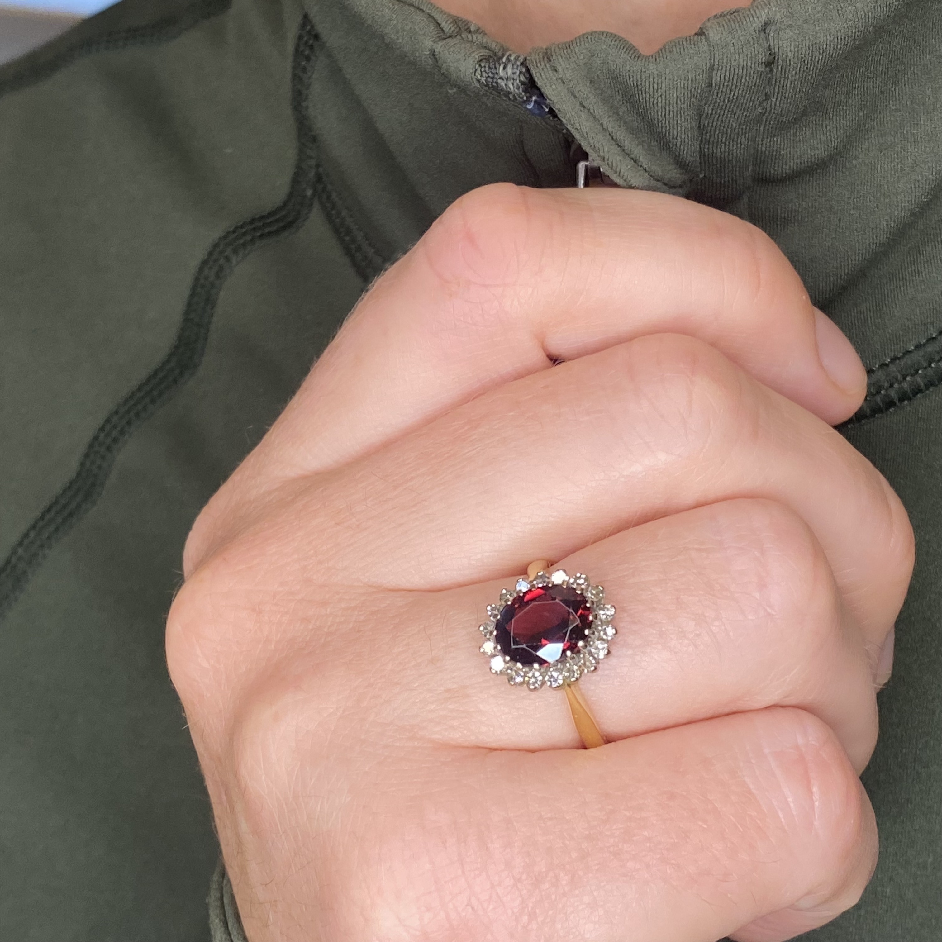 A garnet and diamond cluster ring, the oval-cut garnet claw-set within a surround of single-... - Image 3 of 3