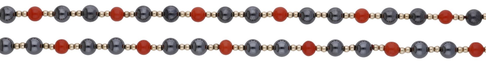 A hematite and coral bead necklace, strung as a single-row of coral corallium rubrum and hem...