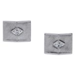 A pair of diamond cufflinks, the pyramidal plaques with a brushed satin finish, the central...