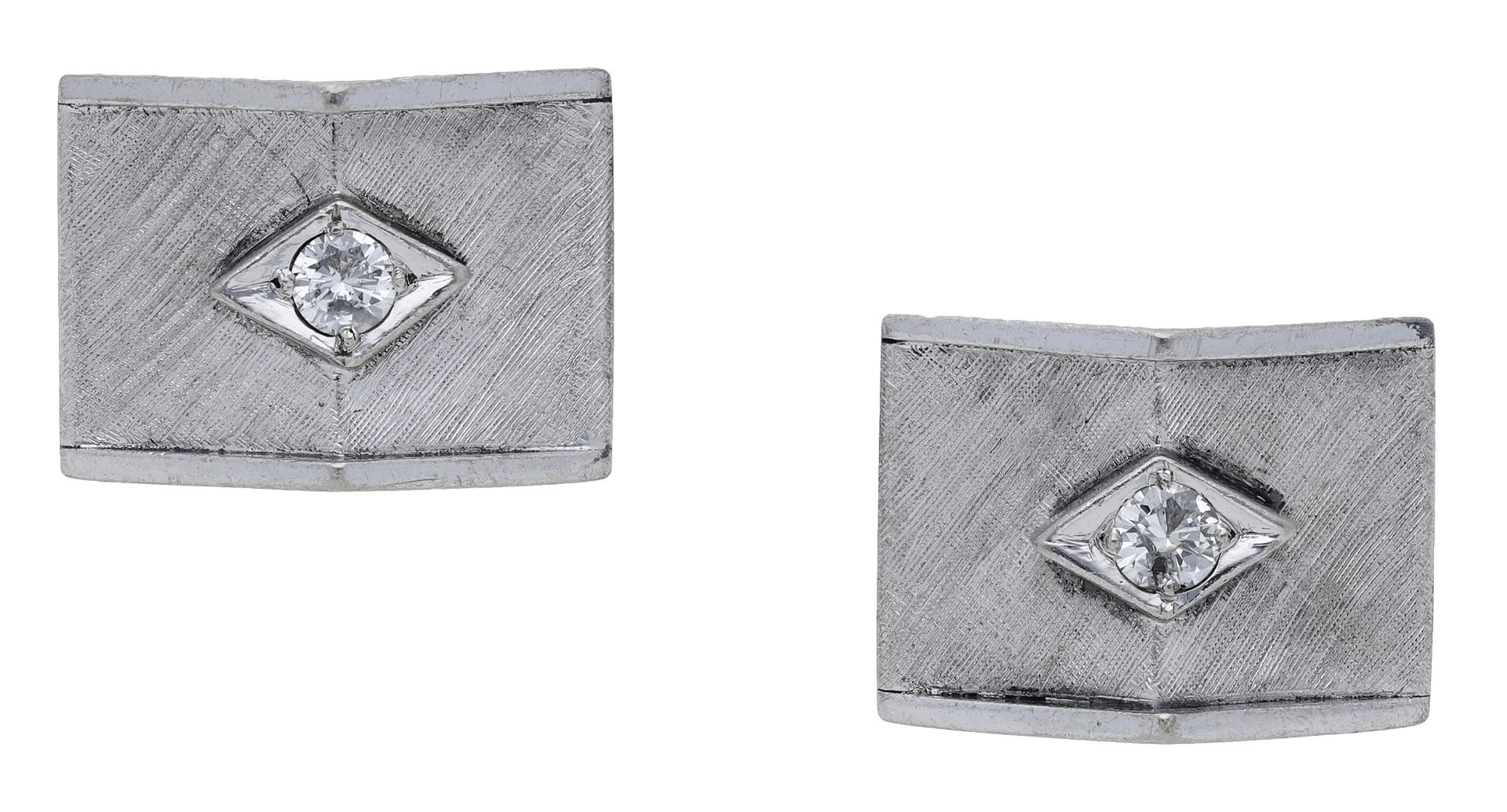 A pair of diamond cufflinks, the pyramidal plaques with a brushed satin finish, the central...