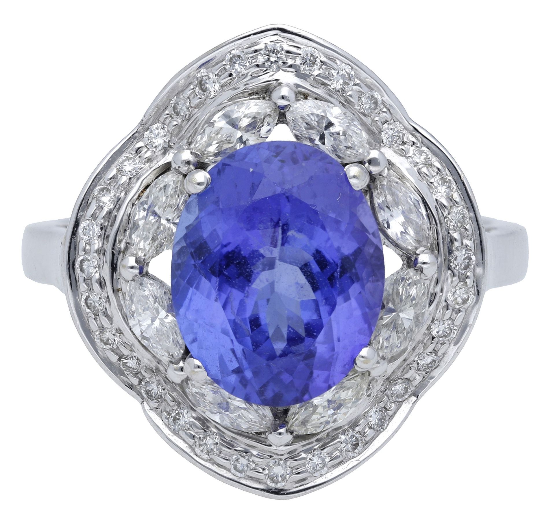 A tanzanite and diamond cluster ring, set with an oval mixed-cut tanzanite within an undulat... - Image 2 of 4