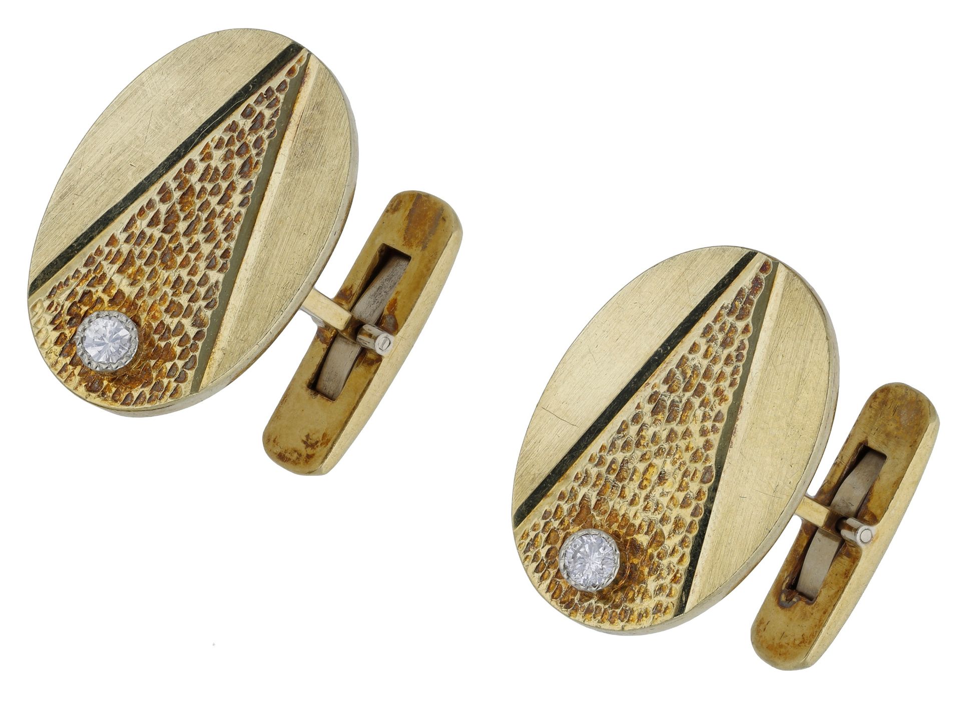 A pair of diamond cufflinks, the oval plaques with brushed satin finish, central textured se...