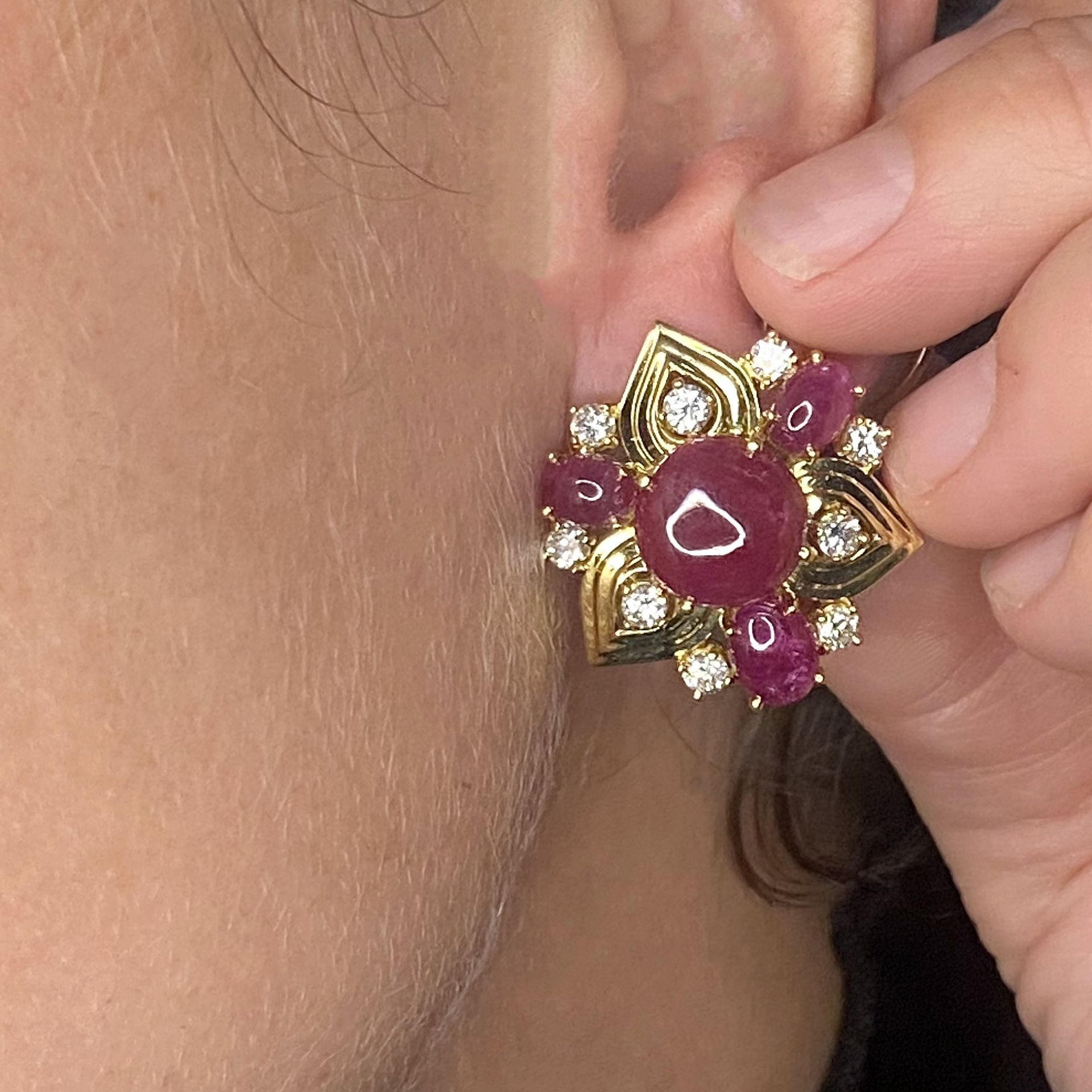 A pair of 18ct gold ruby and diamond earrings, the stylised flowerheads set with circular ru... - Image 3 of 3