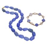 A blue chalcedony necklace and bracelet, the stained blue chalcedony faceted beads strung as...