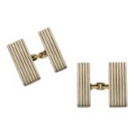 A pair of bicoloured cufflinks, double-sided, each rectangular plaque with reeded decoration...