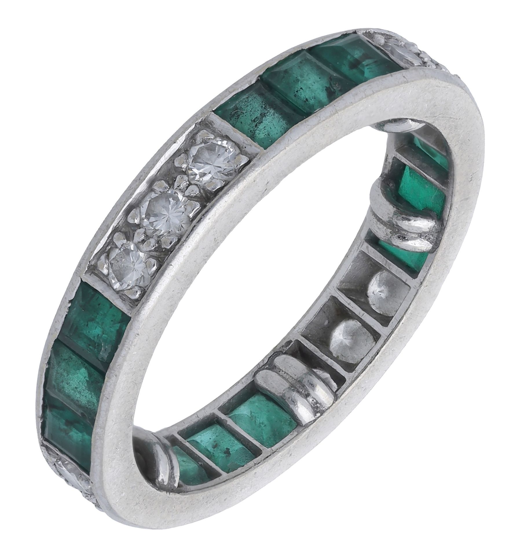 An emerald and diamond eternity ring, set throughout with alternating trios of brilliant-cut...