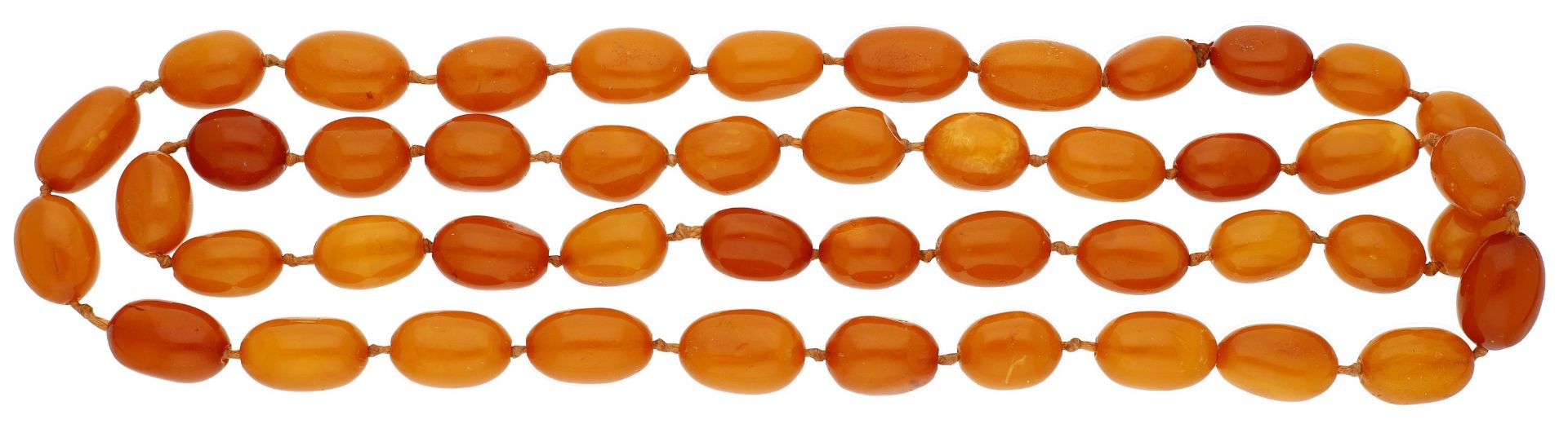 A Baltic amber bead necklace, strung as a single row of polished oval beads, measuring appro...