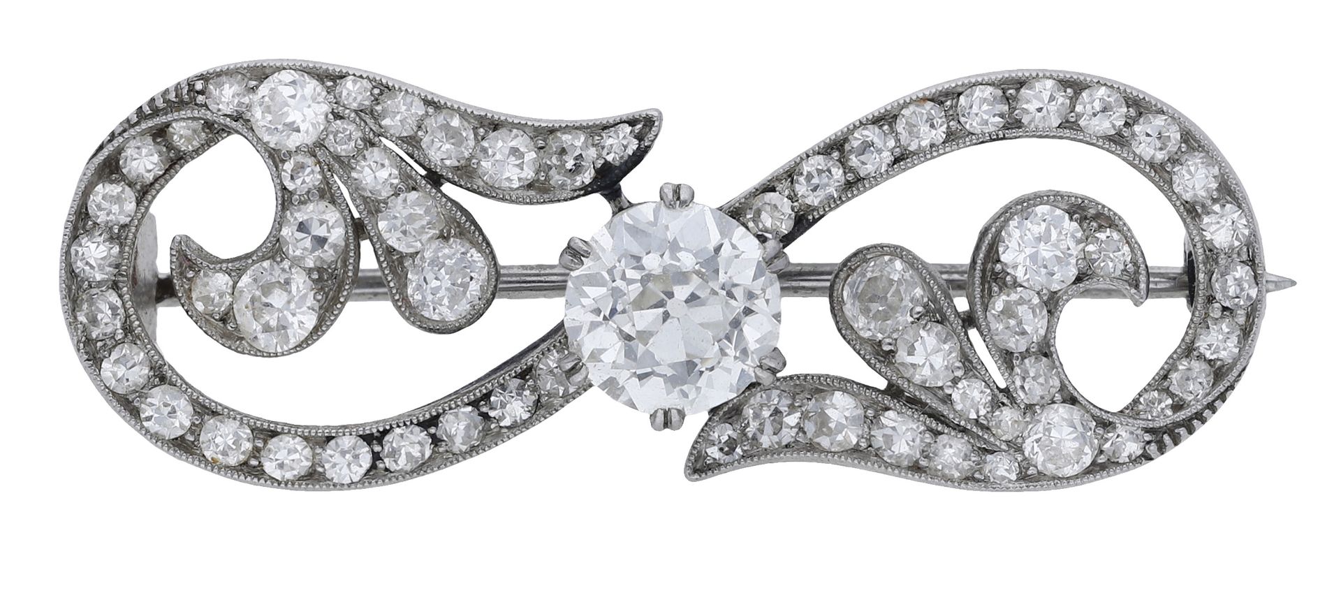 An early 20th century diamond scroll brooch, set throughout with old and single-cut diamonds...