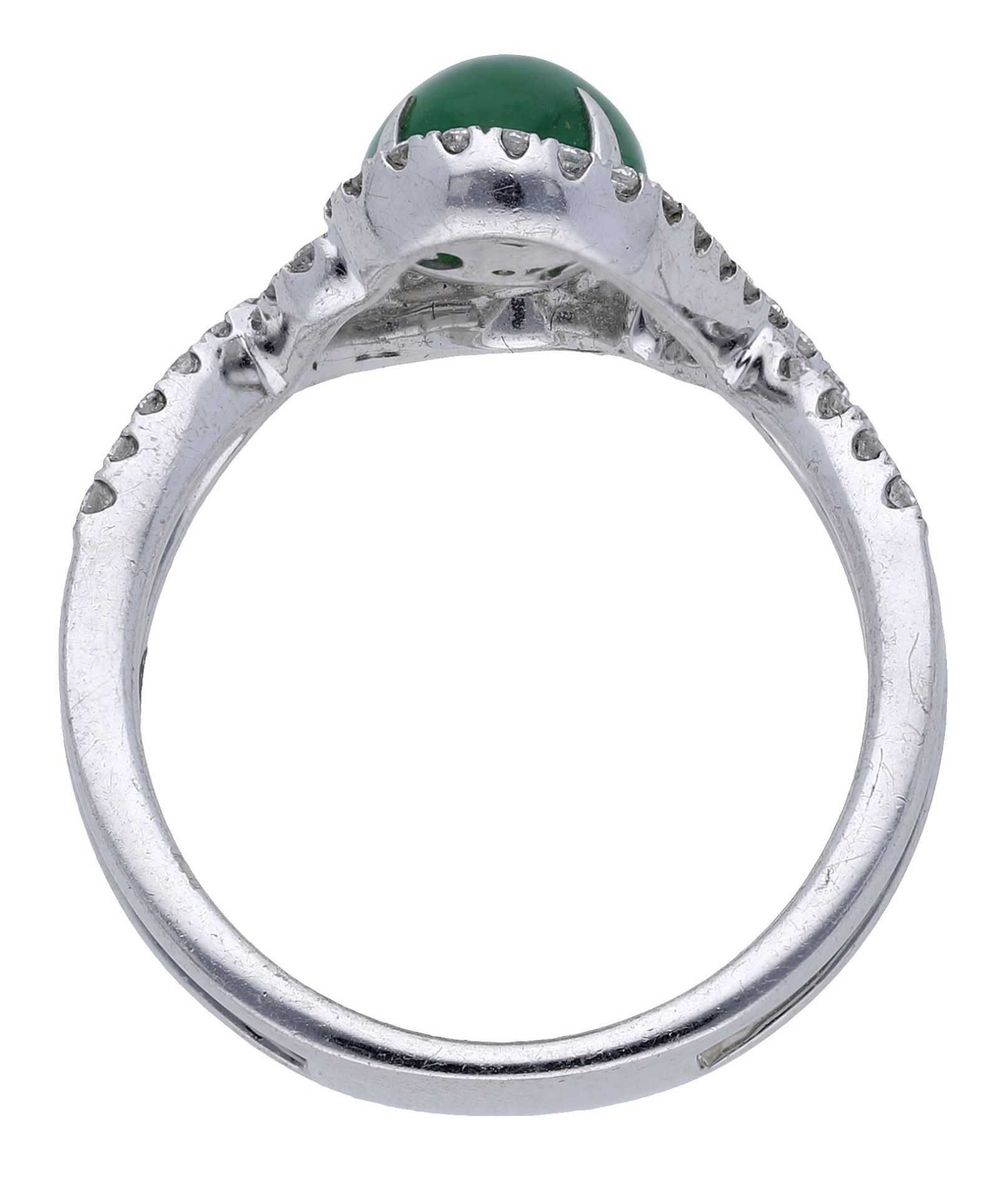 A jade and diamond ring, the jade cabochon claw-set within an entwined surround of brilliant... - Image 2 of 3