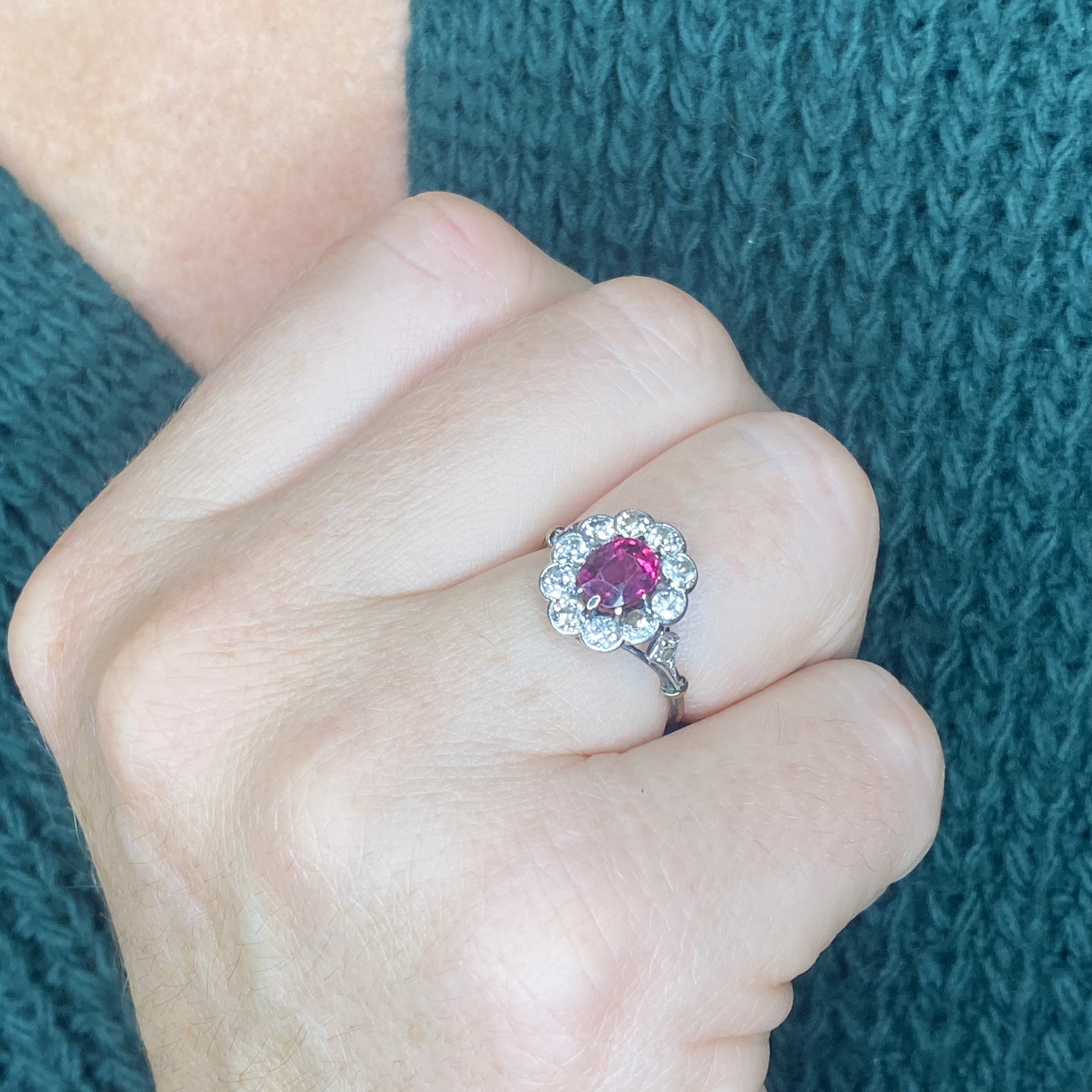 An early 20th century ruby and diamond cluster ring, the oval-cut ruby within a surround of... - Image 3 of 3