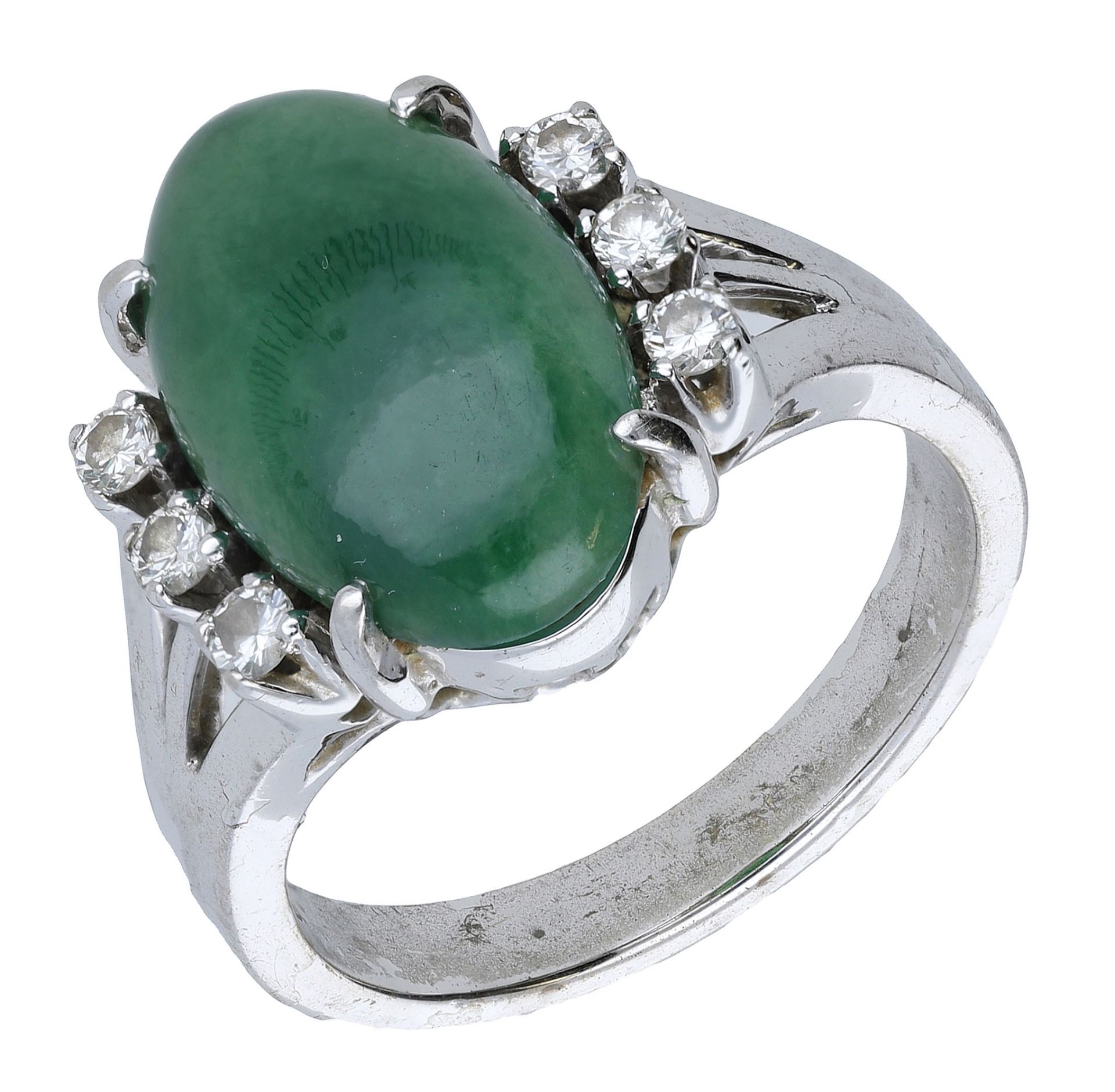 A jade and diamond ring, the oval jade cabochon with a trio of brilliant-cut diamonds to eit...