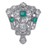 An Art Deco emerald and diamond clip, the tapering clip with foliate detailing and set with...