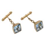 A pair of aquamarine cufflinks, the fancy-cut aquamarines collet-set to chain connections an...