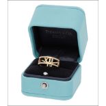 An 'Atlas' ring by Tiffany & Co., the openwork band comprising the Roman numerals 3, 6, 9 an...