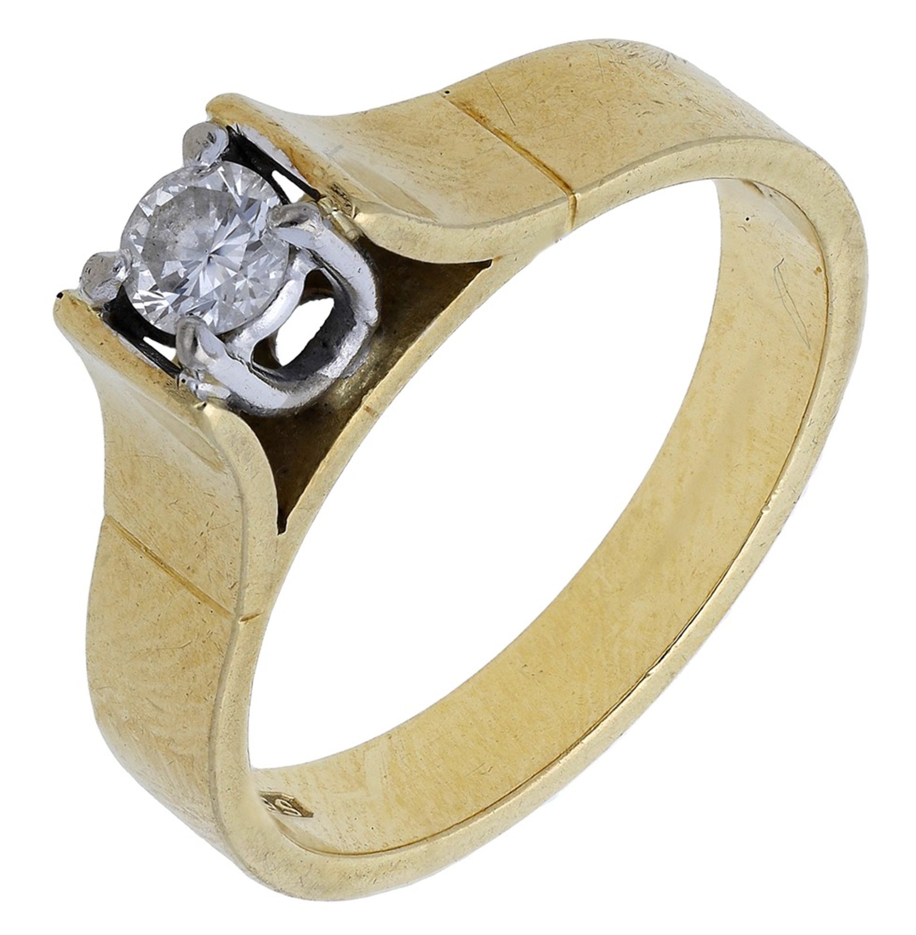 A diamond ring, 1977, set with a brilliant-cut diamond in a raised claw setting, between bro...