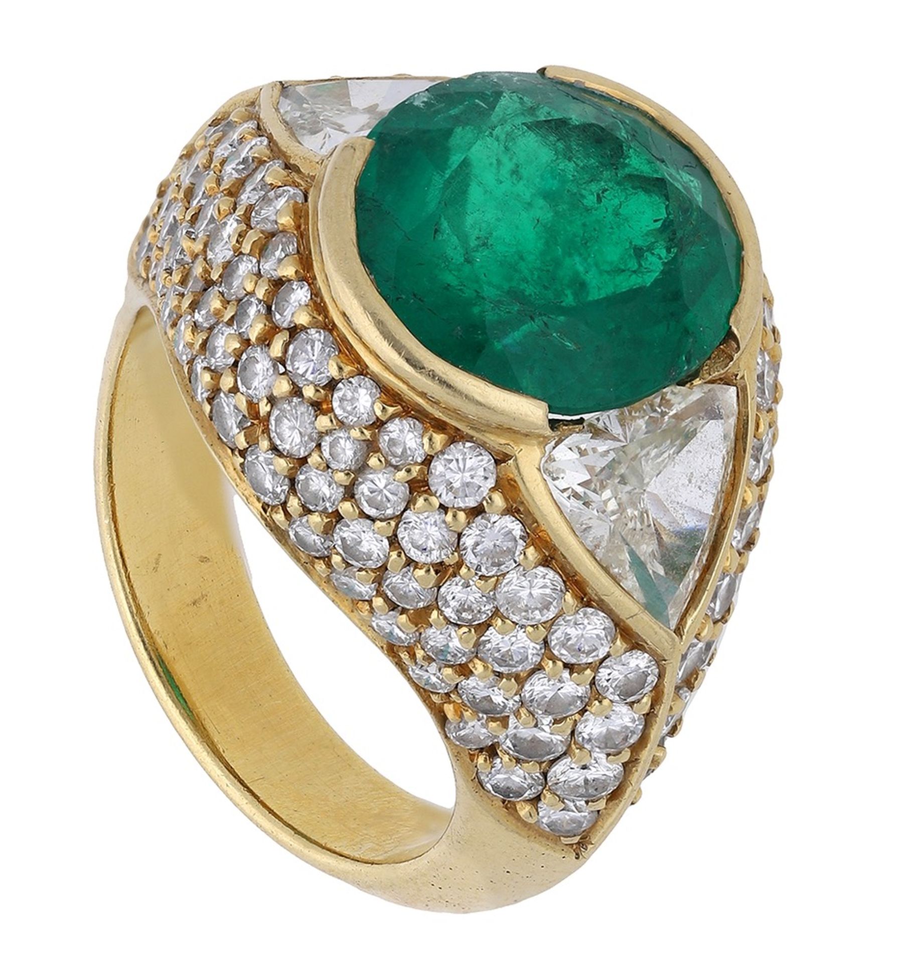 An emerald and diamond dress ring, set with an oval mixed-cut emerald between two triangular...